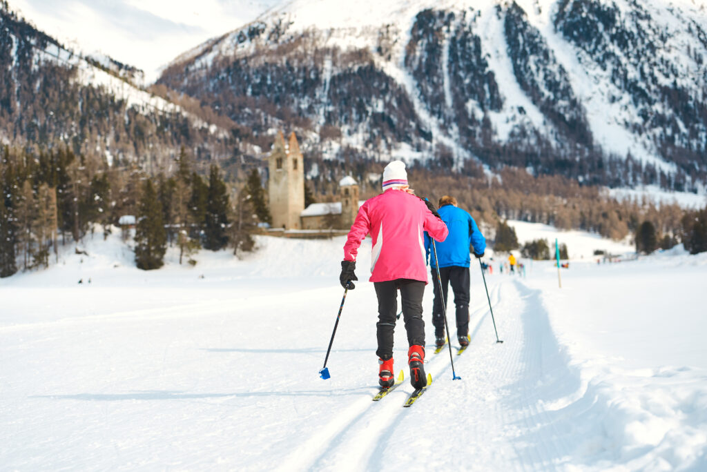 couple of elderly practices cross country skiing